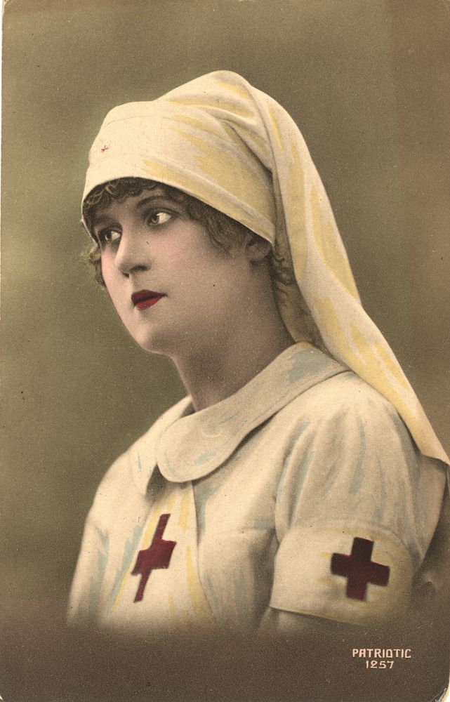 Nurse in White Veil. This is a color photographic postcard of a World War I French nurse. She is shown from the chest up.…