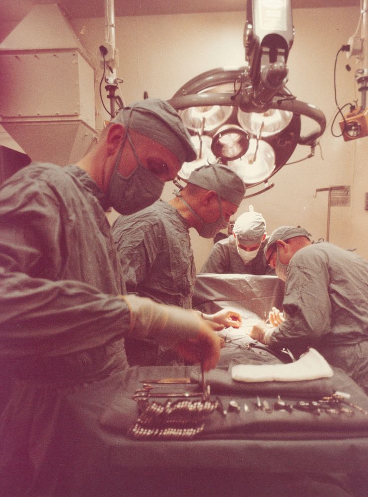 Doctors operating on patient in operating room aboard the USS Repose (AH-16). February 1966. [hospital ship; surgery] K…