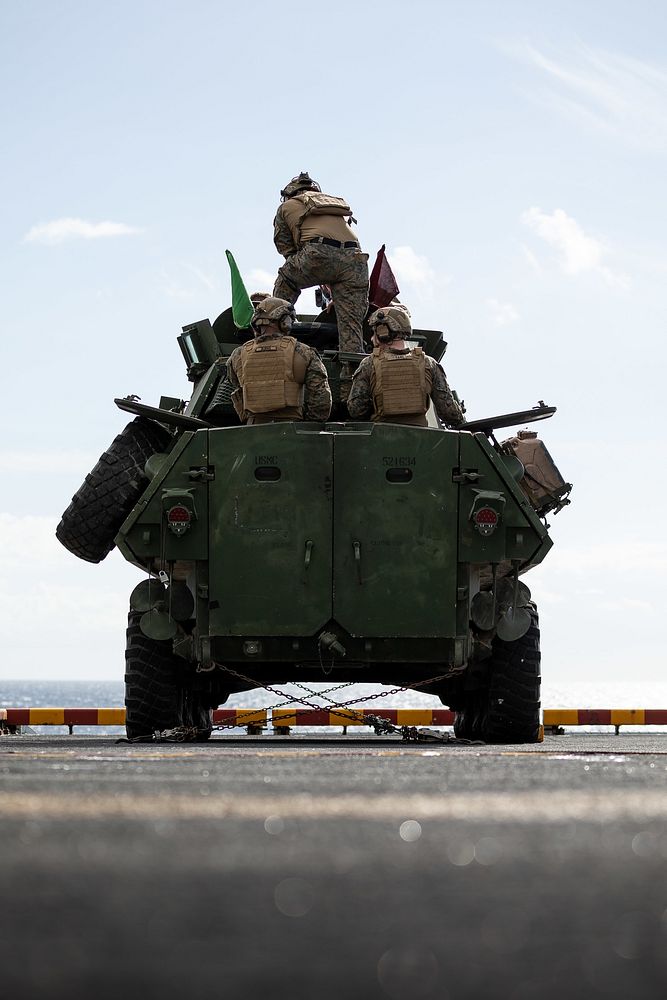 U.S. Marines assigned to the 22nd Marine Expeditionary Unit (MEU), prepare to conduct a live-fire exercise aboard the Wasp…