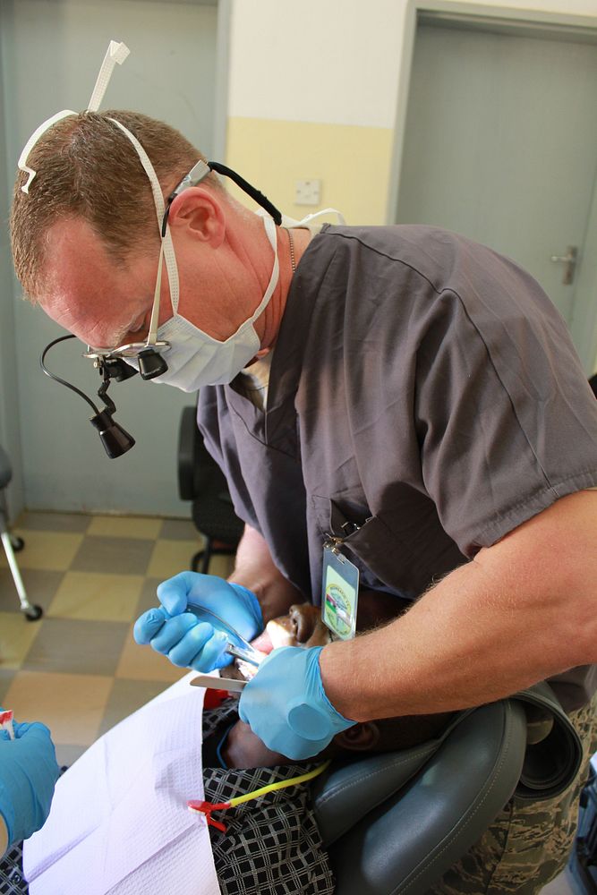 Lilongwe, Malawi- Major Benjamin Armstrong, Dentist in the 349th Aeromedical Dental Squadron, from Boise, Idaho pulls a…