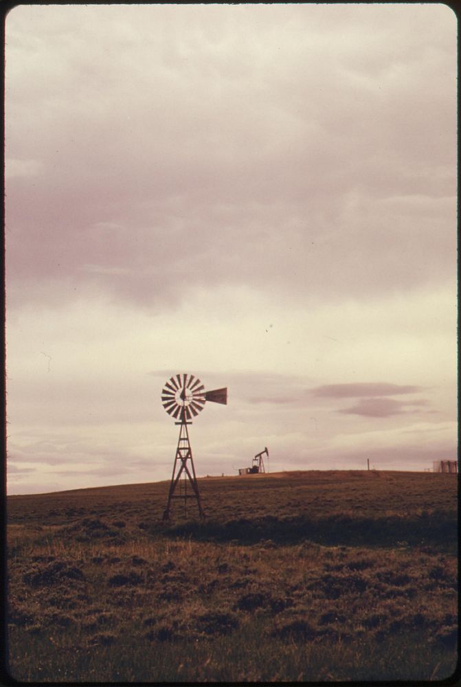 Windmill on the rolling ranch lands near Powder River Wyoming, 06/1973. Photographer: Norton, Boyd. Original public domain…