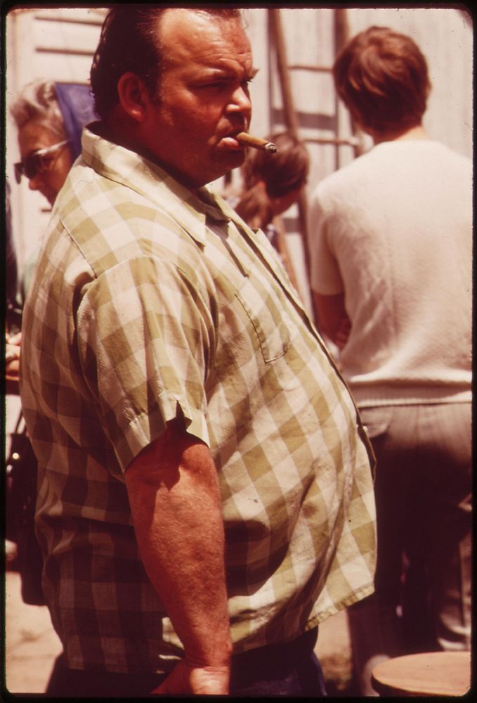 Local man looks over the scene at a Saturday auction near Hickman, May 1973. Photographer: O'Rear, Charles. Original public…