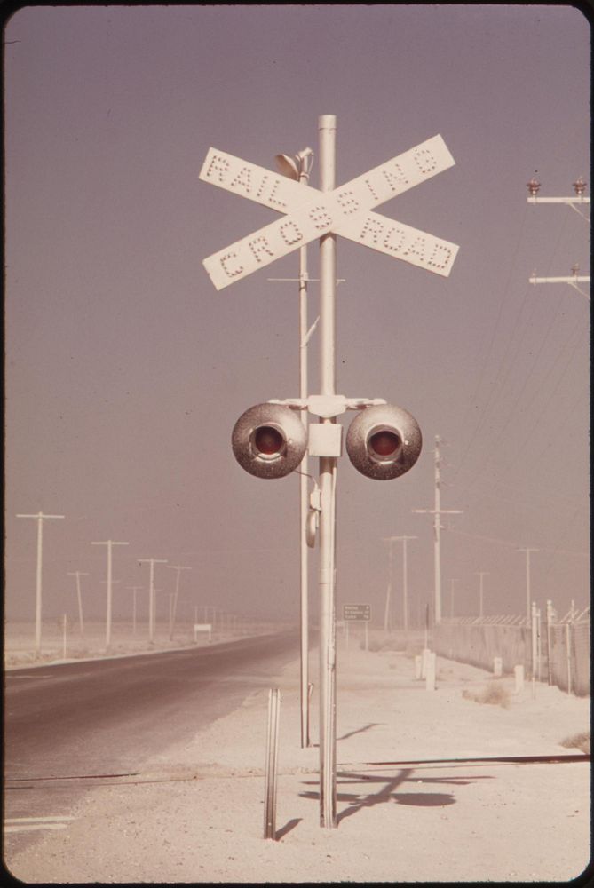 White dust on railroad crossing has floated over from gypsum plant at Plaster City, May 1972. Photographer: O'Rear, Charles.…