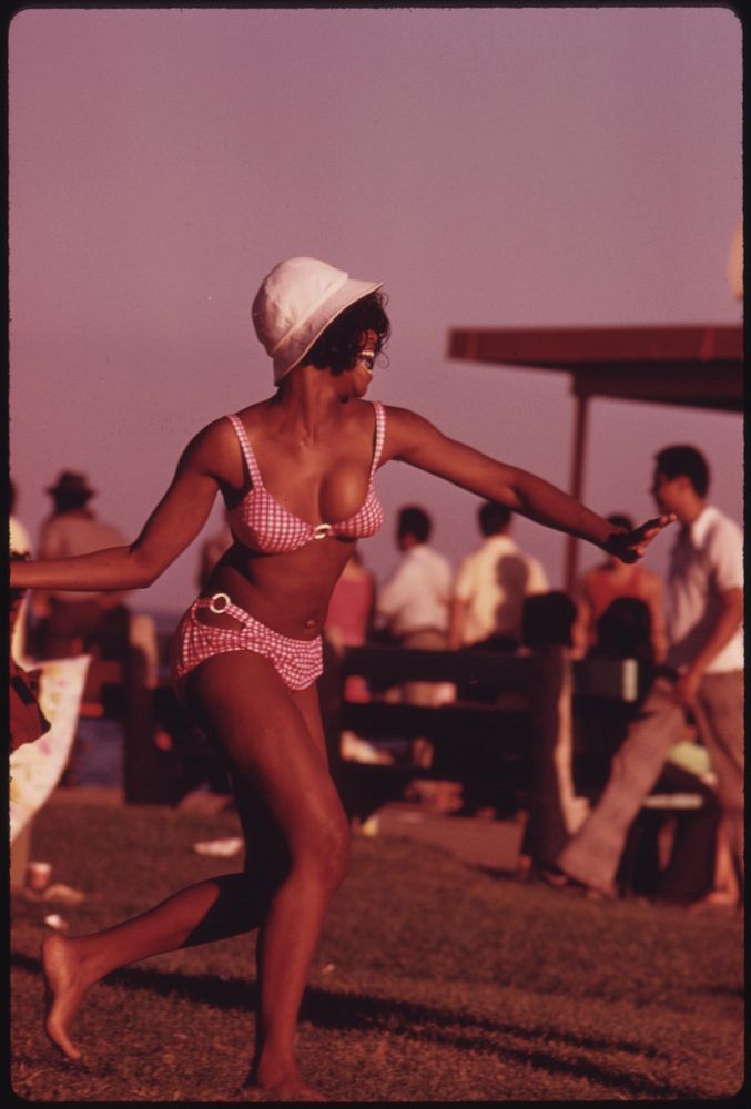 A Swimsuit Clad Black Woman Enjoys Her Summer Outing At Chicago's 12th Street Beach On Lake Michigan, 08/1973. Photographer:…