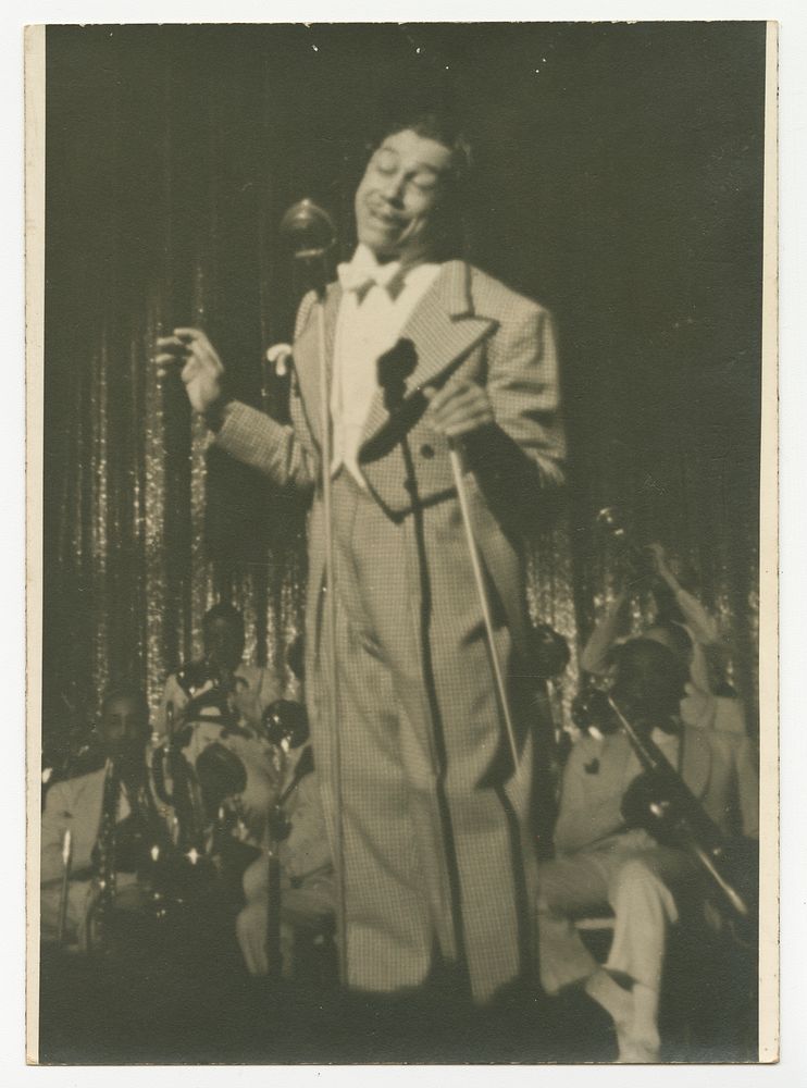 Print of Cab Calloway in checked suit standing in front of microphone, National Museum of African American History and…