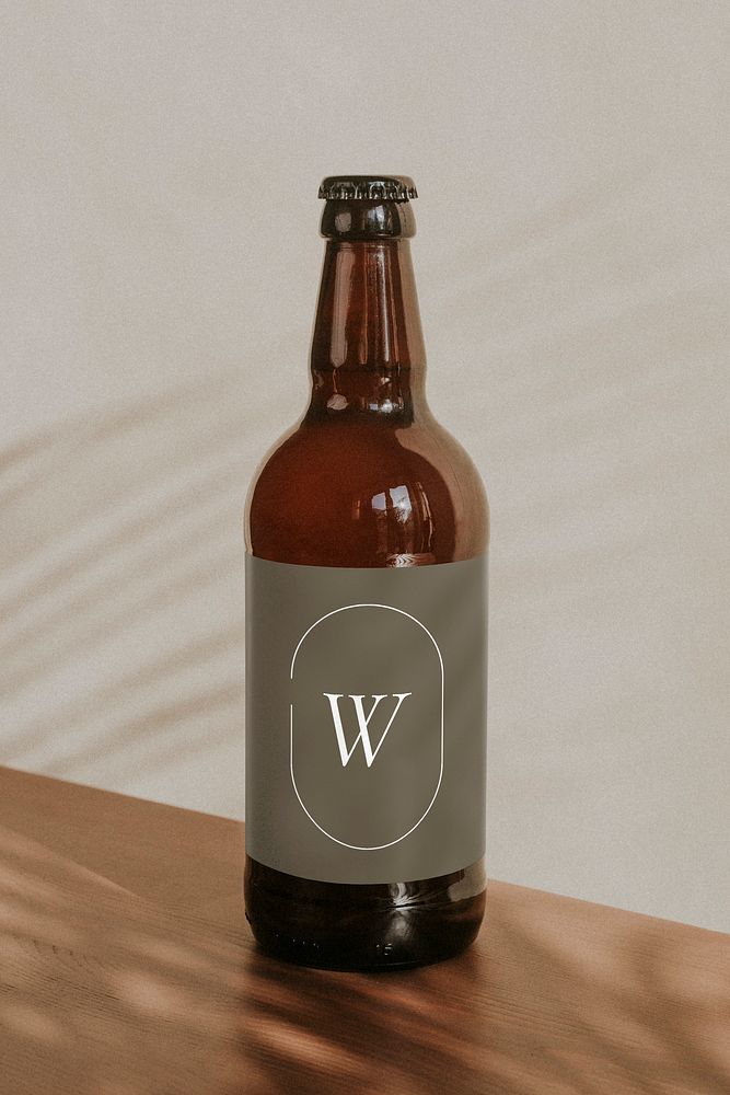 Brown beer bottle on wooden background mockup