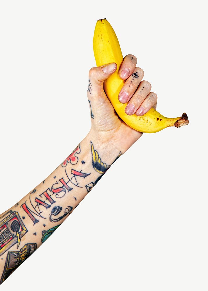 Tattooed hand holding banana psd