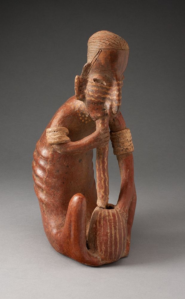 Seated Figure Drinking from a Vessel using a Tube by Colima