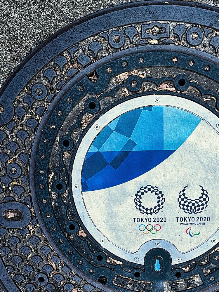 Tokyo 2020 Olympics Logos on Maintenance CoverA maintenance hole cover with logos of the Tokyo 2020 Olympics. It was outside…