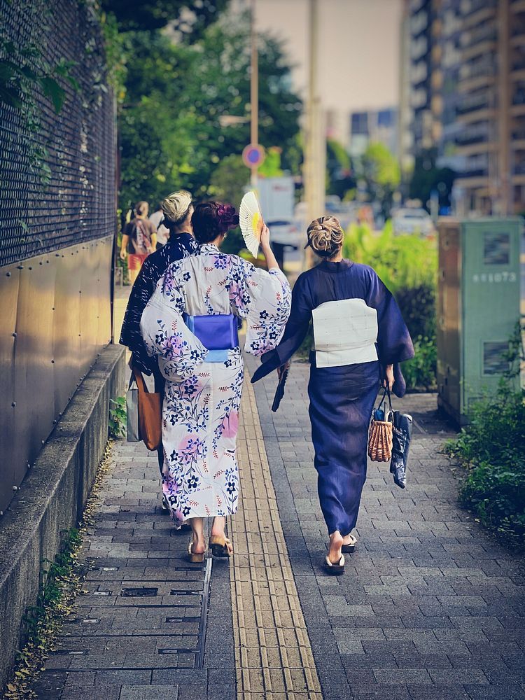 People Wearing Yukata, Tokyo, JapanYoung Japanese wearing yukata (summer kimono) walking on a sidewalk, Ikenohata, Taito…