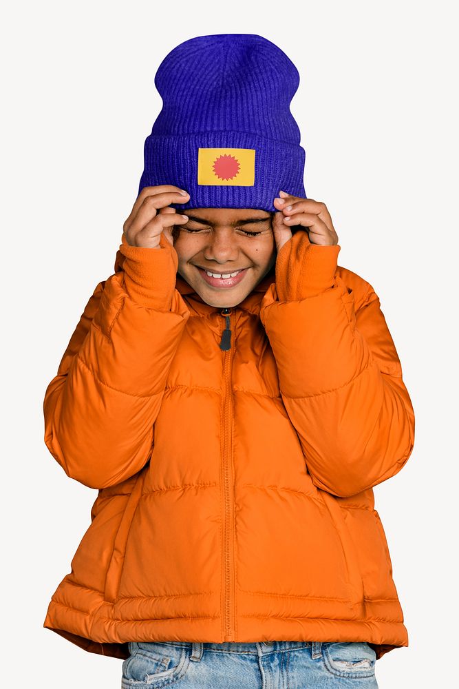 happy girl in orange puffer jacket & blue beanie