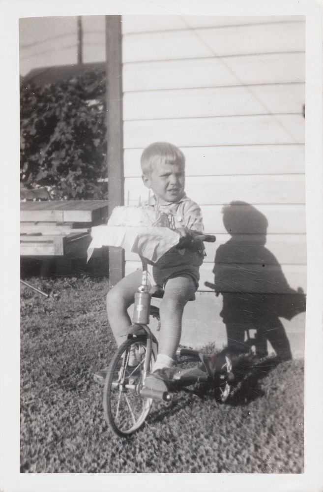 Untitled (Little Boy on a Tricycle with Cake)