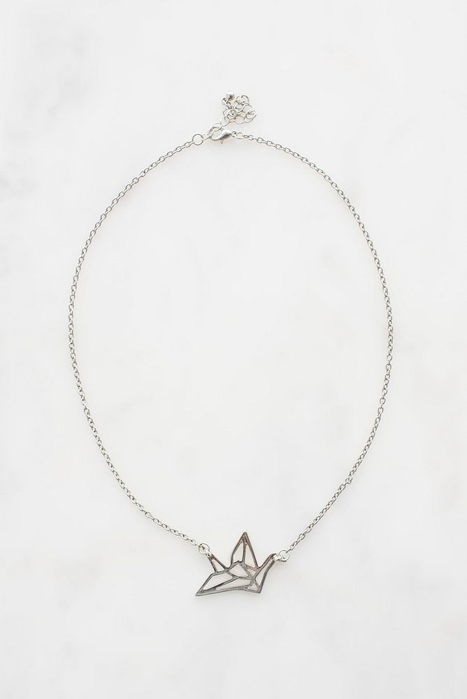 Silver origami crane necklace.