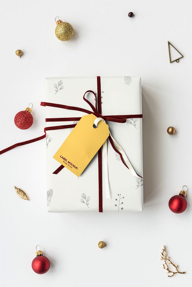 Gift box wrapped with floral patterned paper with a tag mockup