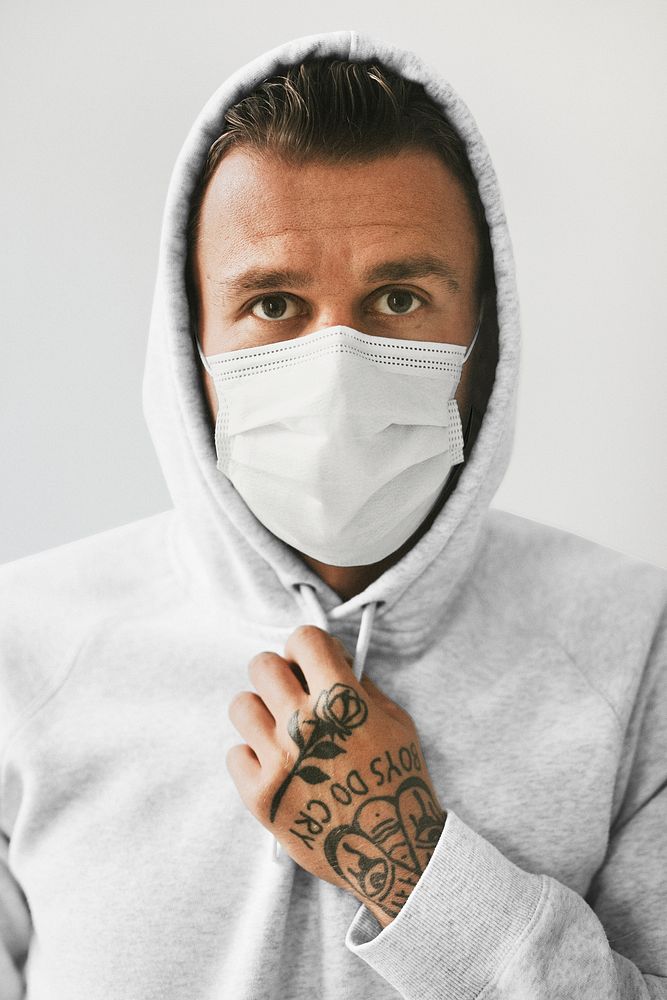 Face mask mockup on a man in a hoodie psd
