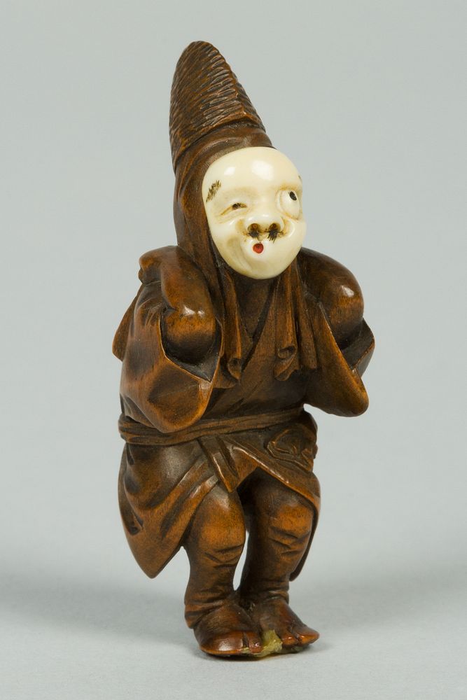 Netsuke of Boy Wearing an Ivory Mask