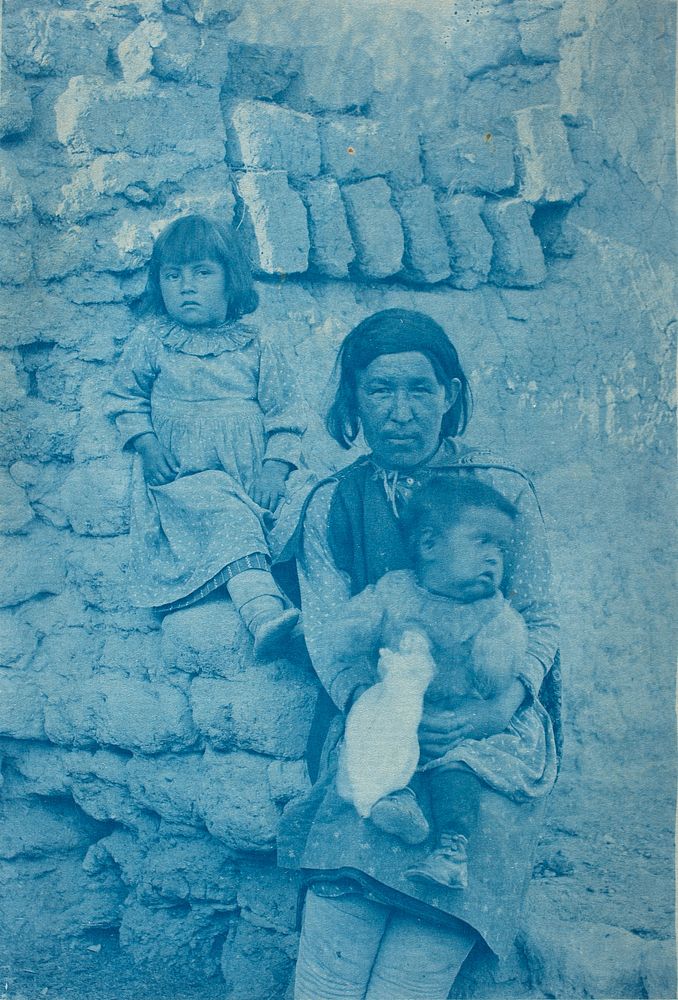 A Pueblo woman with two children by Charles F Lummis