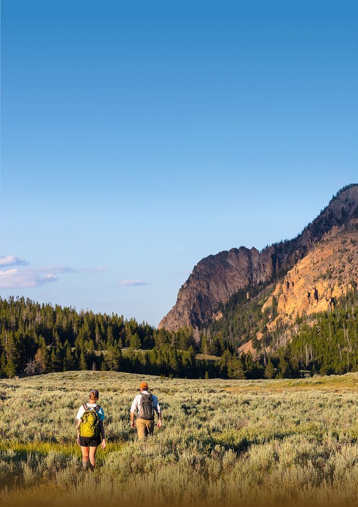 Mountain landscape background, travelers walking through grass