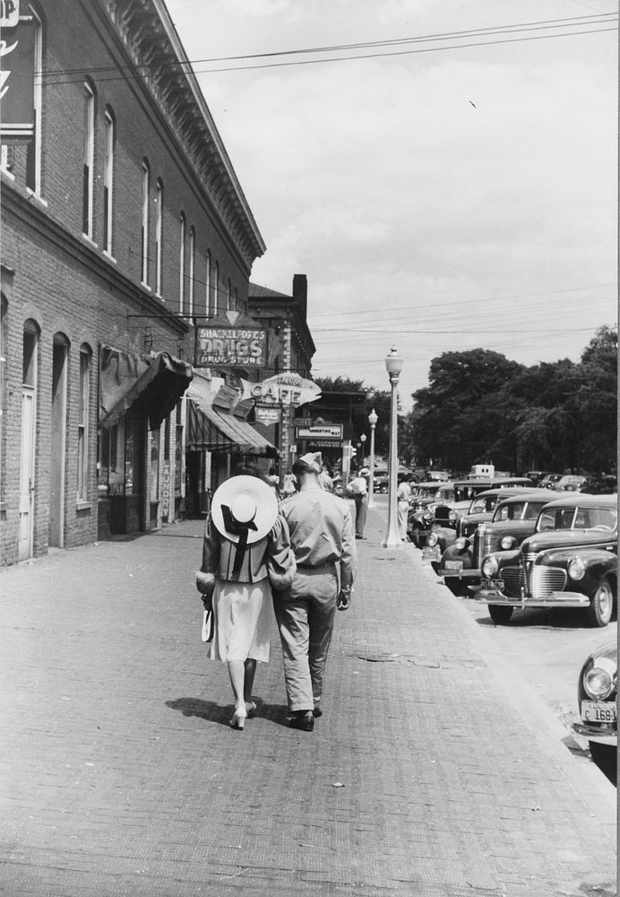 Soldier from Fort Benning and girlfriend on a street in Columbus, Georgia. Sourced from the Library of Congress.