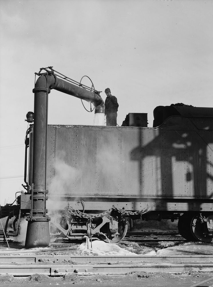Chicago, Illinois. Getting water for an engine at a Chicago and Northwestern coaling station. Sourced from the Library of…