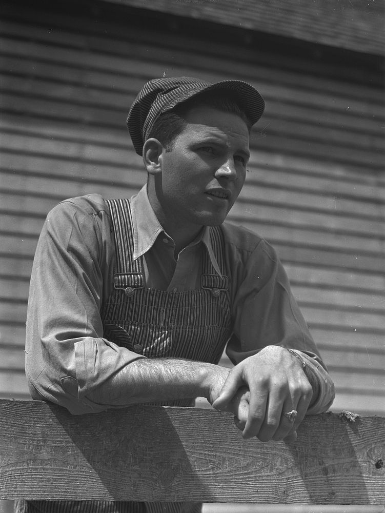 Gene Cooper, student at Iowa State College visits his family on their farm near Ames, Iowa. Sourced from the Library of…