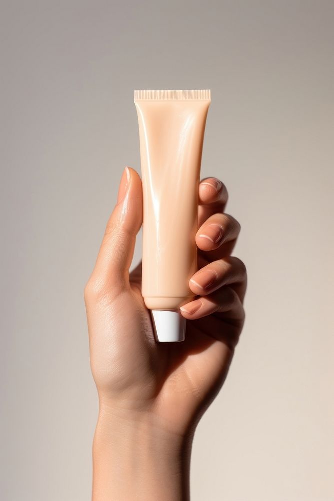 Cosmetics holding hand sunscreen. AI generated Image by rawpixel.