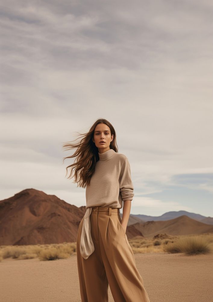 A woman standing wearing a minimal colorful outfit outdoors desert nature. AI generated Image by rawpixel.
