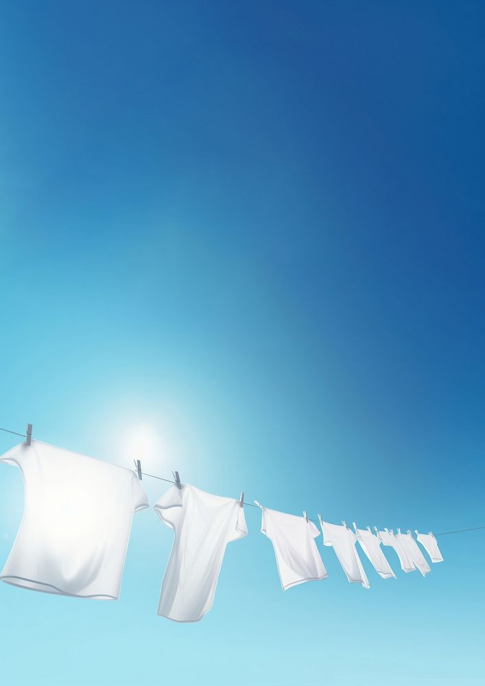 Eco friendly laundry drying on shirt line against a blue sky blackground. AI generated Image by rawpixel. 