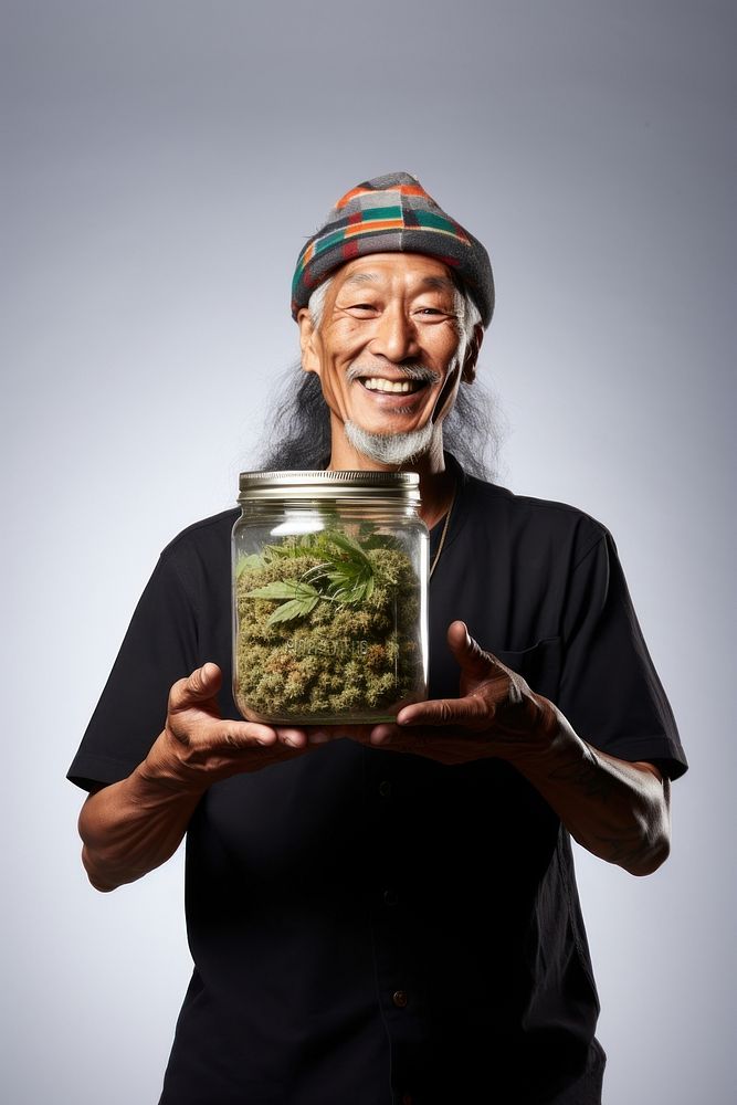 Male holding marijuana adult happy jar. 