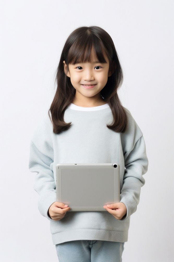 Girl holding tablet computer portrait child. AI generated Image by rawpixel.