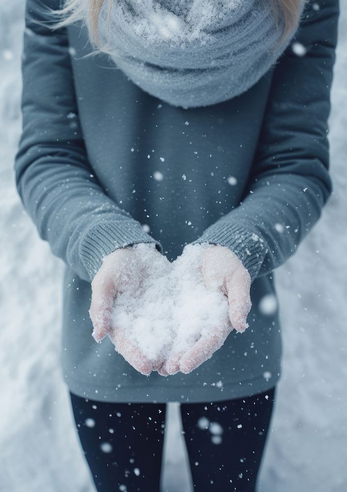 Holding snow outdoors adult glove. 