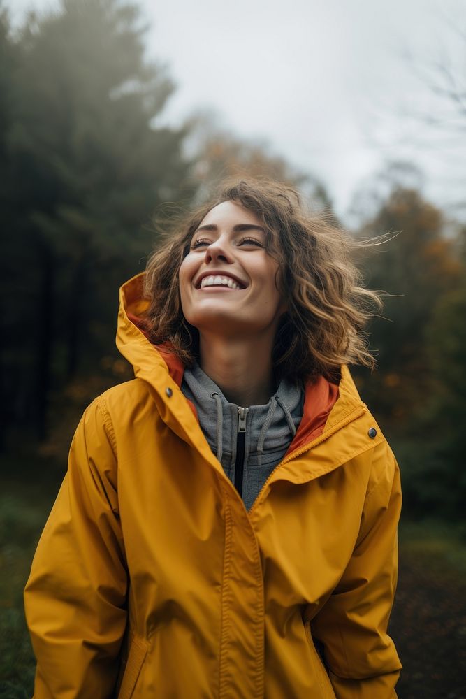Raincoat laughing outdoors jacket. AI generated Image by rawpixel.