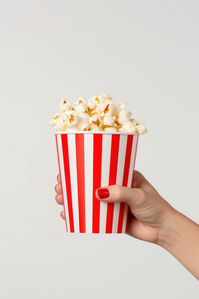 Delicious popcorn cup striped holding. 