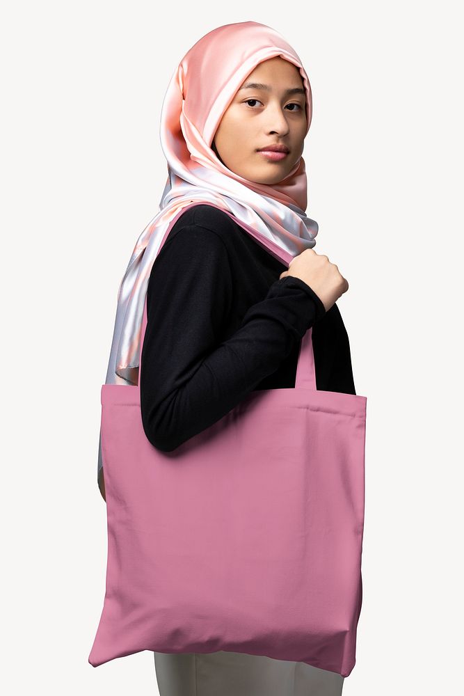 Muslim woman carrying pink tote bag