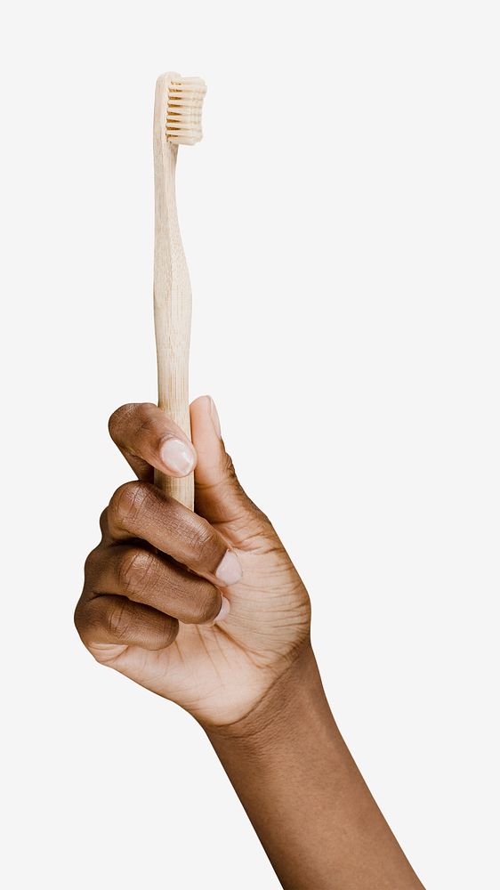 Hand holding a wooden toothbrush isolated image