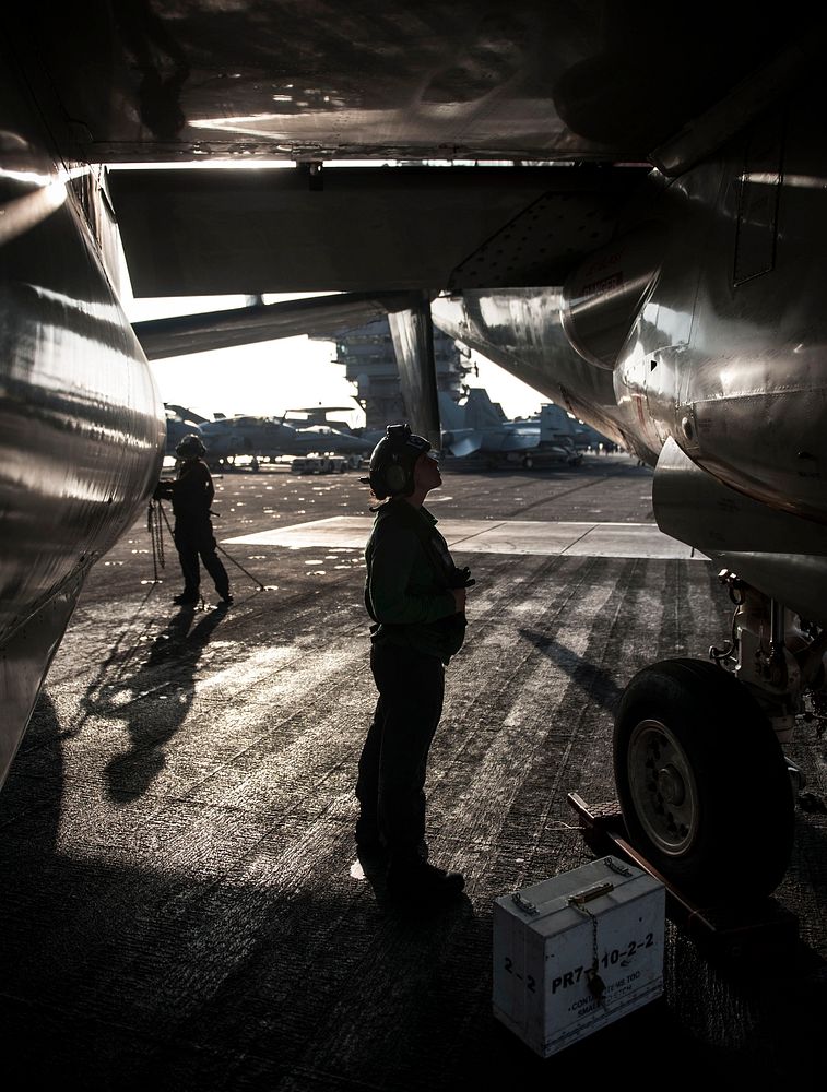 U.S. Navy Aviation Electronics Technician Airman Alison Guzik checks the exhaust of an E-2C Hawkeye aircraft assigned to…