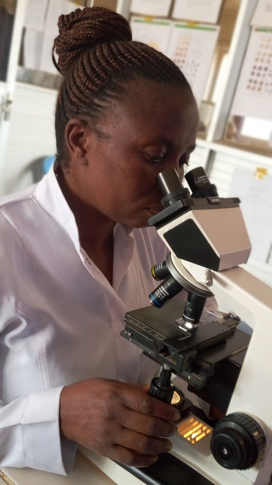 Laboratory technician, Thérèsa, views a slide through her microscope.
