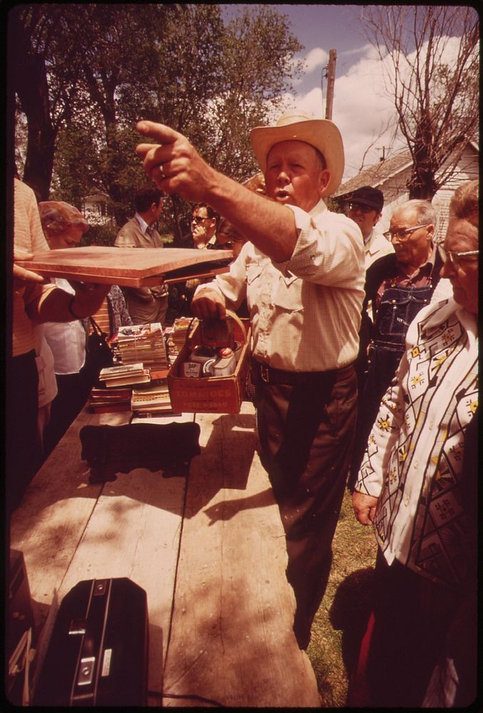Auctioneer does brisk business at the Hickman Saturday Auction, 15 miles south of Lincoln, May 1973. Photographer: O'Rear…