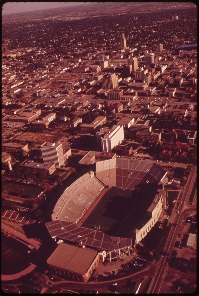 Lincoln, the capital city, seen from the air. In foreground is the University of Nebraska stadium, May 1973. Photographer:…