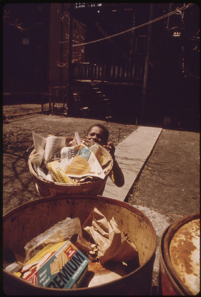 Black Youngster Taking Out The Trash On Chicago's South Side, 05/1973. Photographer: White, John H. Original public domain…