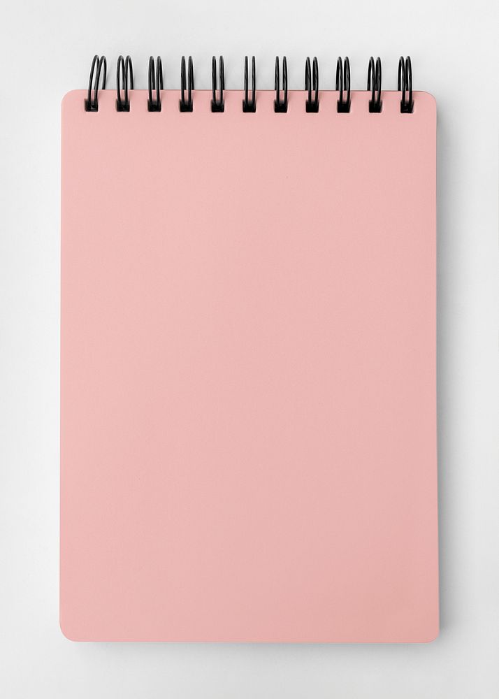 Blank pink ruled notebook mockup on a white table