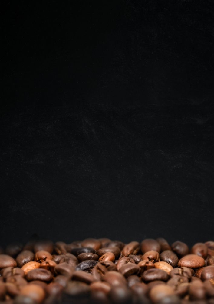 Roasted coffee beans, dark image with copy space