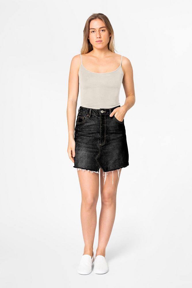 Woman in Summer fashion, beige tank top & denim mini skirt