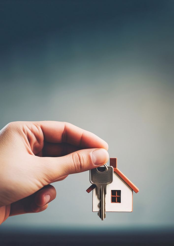 close up photo of black hand holding house key.  