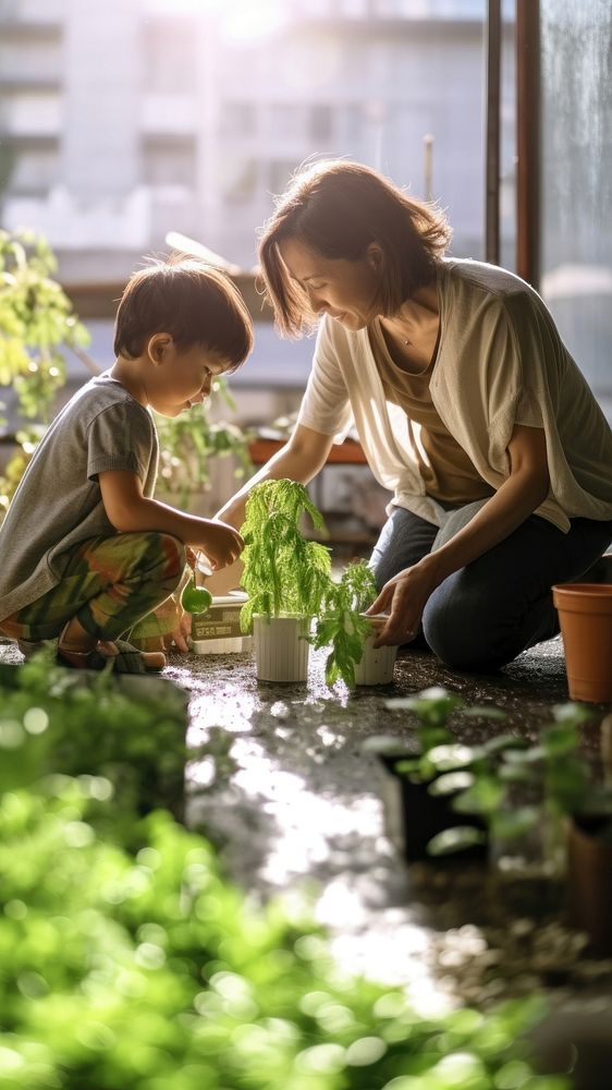 photo a Mother and son watering vegetables in their urban garden. AI generated Image by rawpixel. 