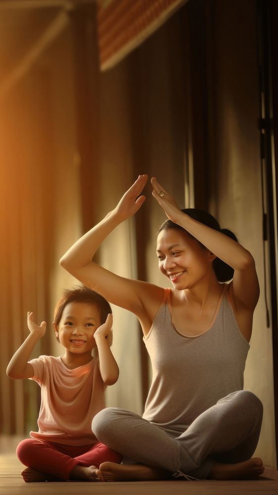 Photo of asia girl do yoga pose with her mom.  