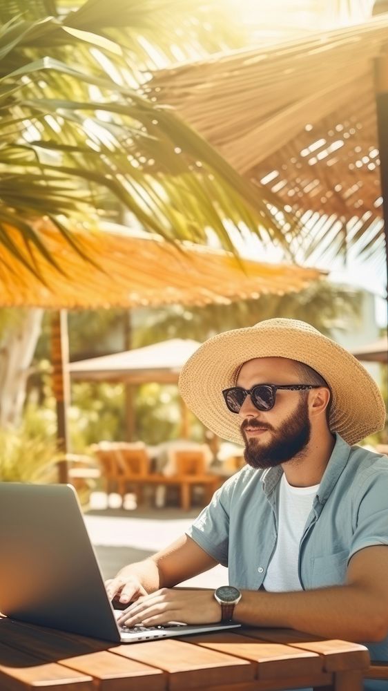 Young man freelancer traveler working online using laptop while traveling on summer vacation. AI generated Image by rawpixel.