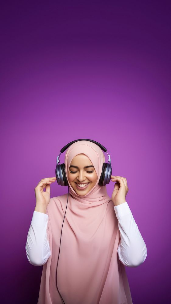 photo of a muslim woman wearing headphones.  