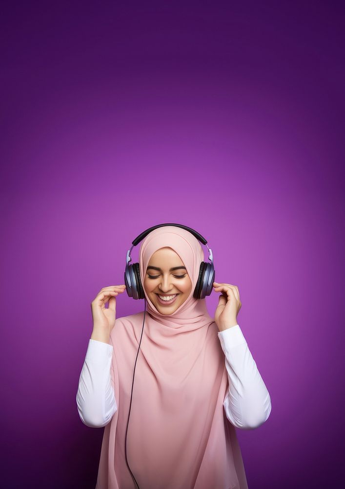 photo of a muslim woman wearing headphones.  