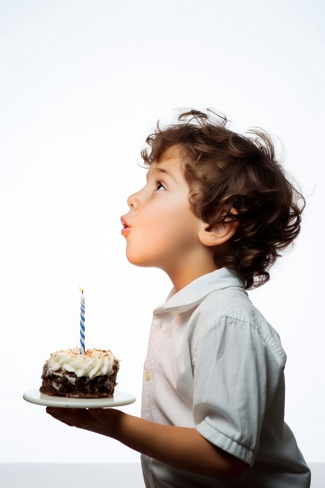 Kid blowing birthday cake dessert candle party. AI generated Image by rawpixel.
